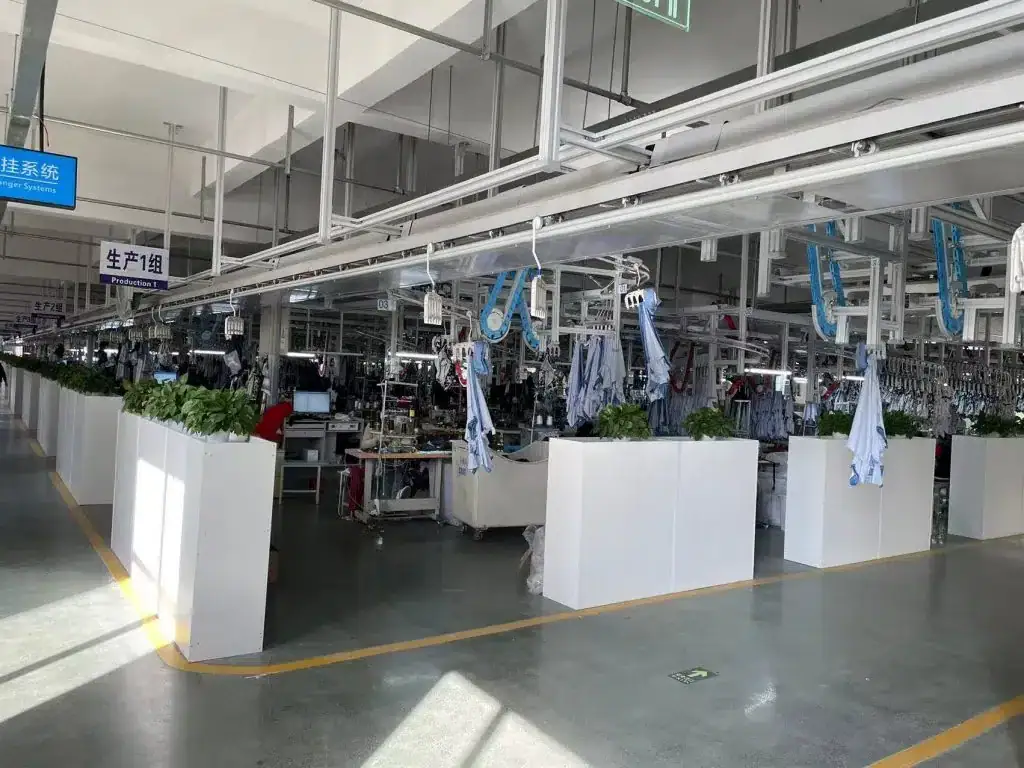 Modern apparel manufacturing factory with sewing stations and uniform production lines in China.