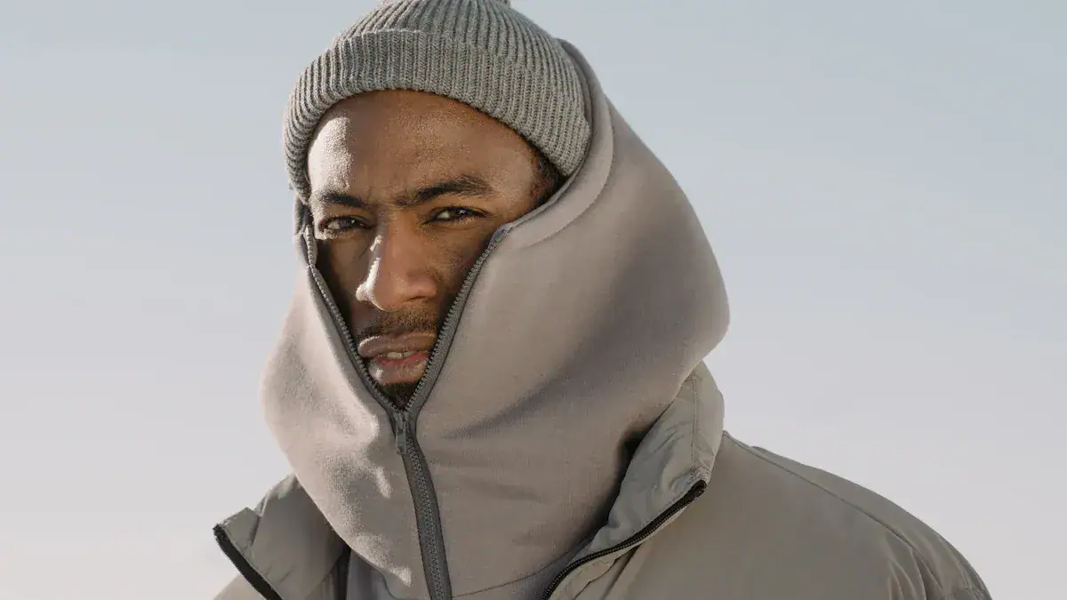 Warm winter hoodie with zip-up front and high collar for cold weather, styled with gray beanie, suitable for outdoor work and casual wear.