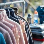 Comfortable fleece jackets in various colors hanging on a clothing rack, showcasing quality workwear uniforms for outdoor and industrial jobs.
