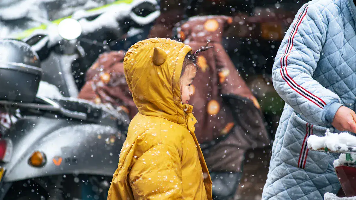 Yellow raincoat with hood, protecting a child from snow and rain, outdoor weather, winter clothing.