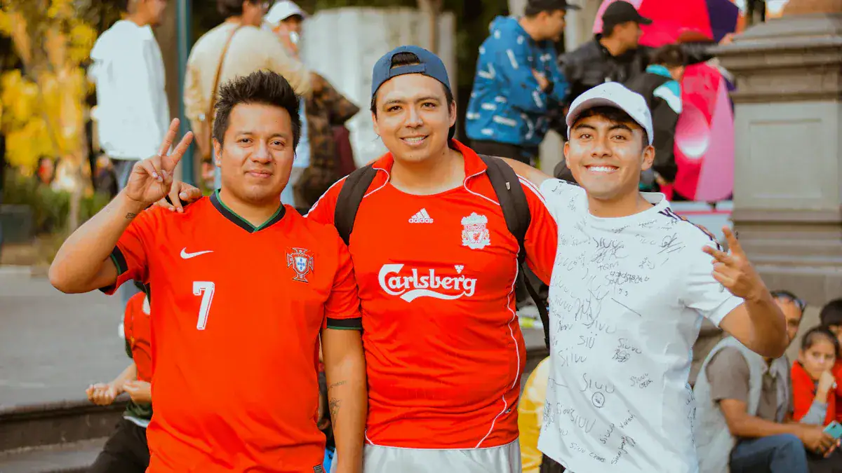 Brightly dressed friends in casual sportswear enjoying outdoor event, smiling and making peace signs.