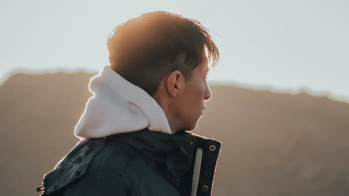 Men wearing custom workwear jackets outdoors at sunset, emphasizing high-quality, durable uniforms manufactured in China.