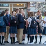 Custom school uniform clothing for students in China, featuring coordinated blouses, skirts, and jackets with backpacks, promoting a professional and uniform appearance.