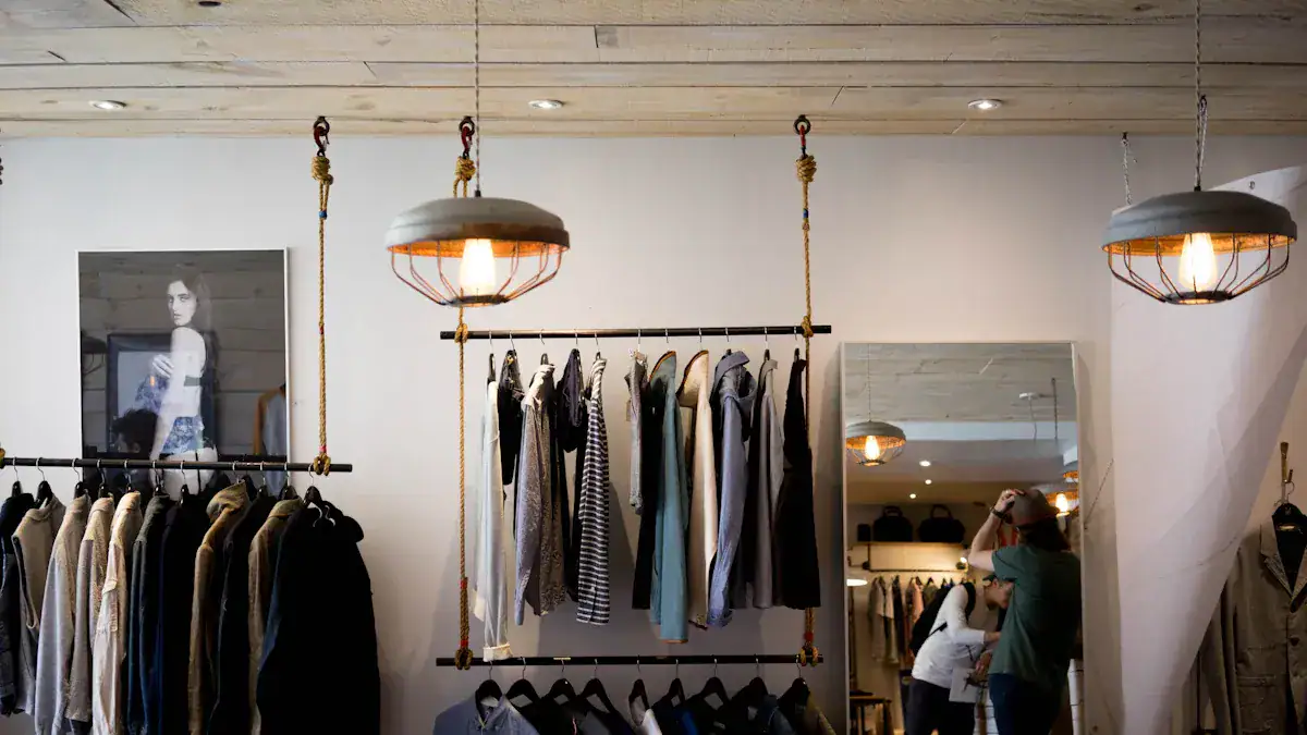 Workwear clothing display in retail store, custom uniforms, casual and formal apparel, apparel racks, modern interior decor, customer shopping experience, apparel boutique, clothing store design, fashion retail environment, Sha manufacturing site.