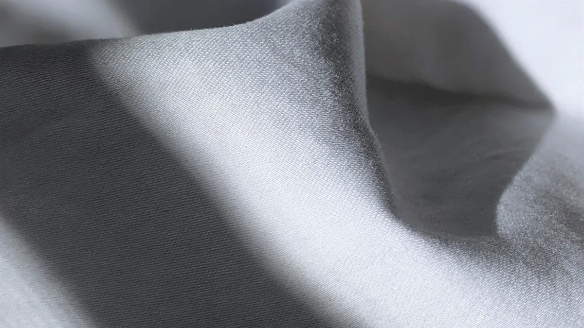 Luxurious silver satin fabric with smooth texture and subtle sheen, ideal for custom uniforms and high-quality apparel manufacturing. Perfect for stylish, durable workwear and promotional clothing.