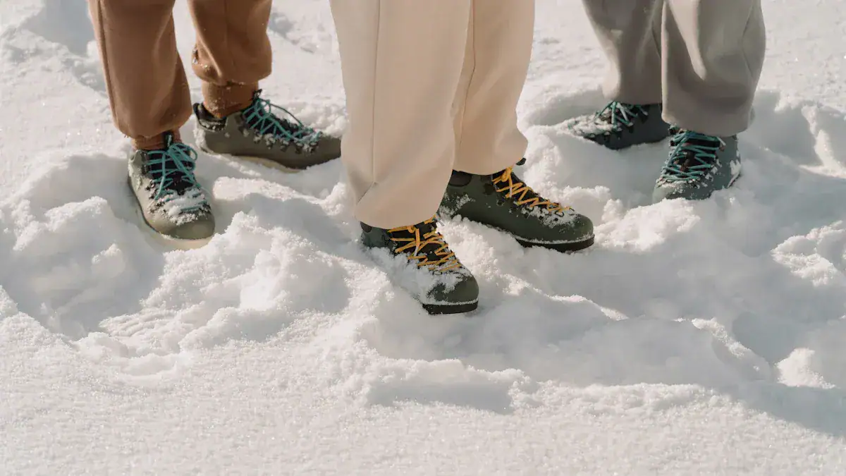 Warm waterproof winter boots worn by people standing on snow, ideal for outdoor winter activities and cold weather protection.