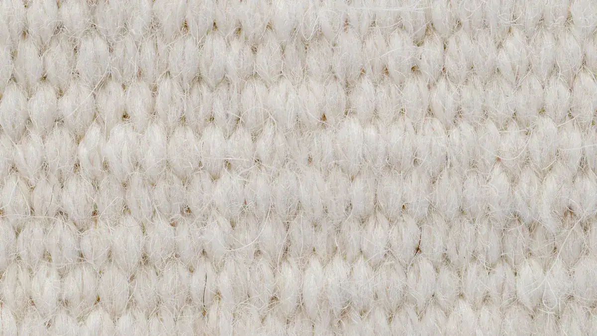 Soft cream-colored textile fibers used in custom workwear uniforms, showcasing high-quality fabric suitable for manufacturing durable clothing.