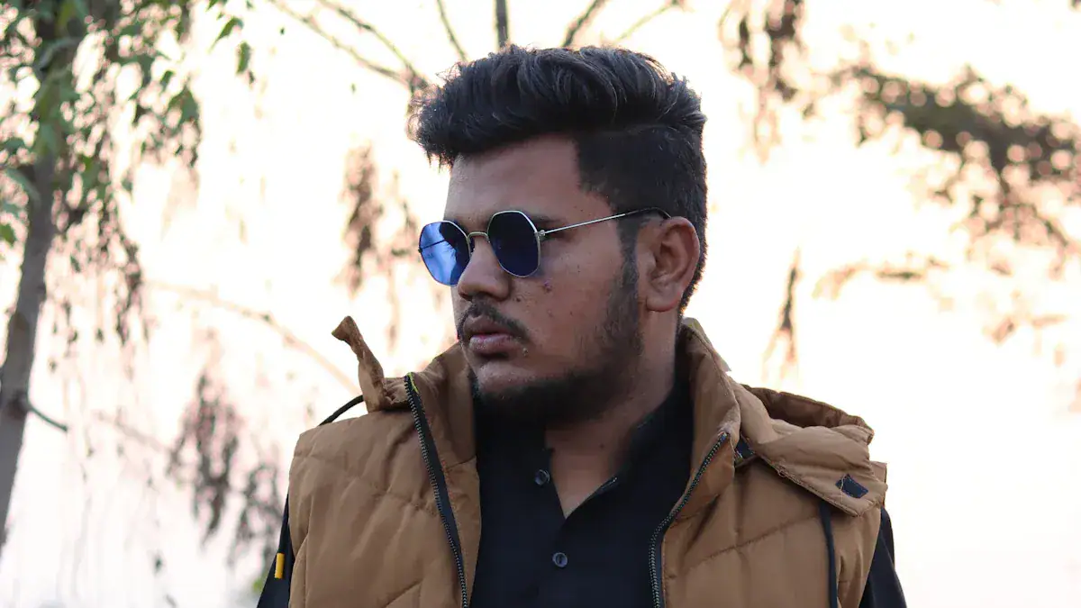 Stylish young man wearing custom outdoor clothing and sunglasses, showcasing durable workwear jackets designed for comfort and functionality by a leading China-based manufacturer.