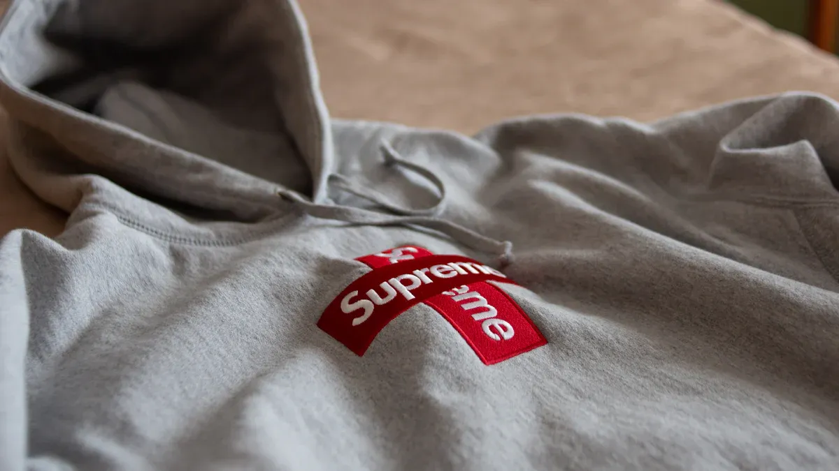 Supreme logo hoodie, casual streetwear sweatshirt with red and white branding, comfortable and stylish for everyday wear.