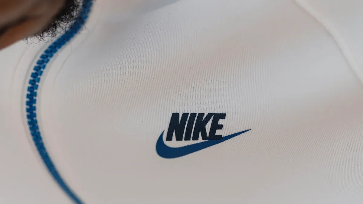 Nike logo embroidered on white sportswear fabric, close-up view.