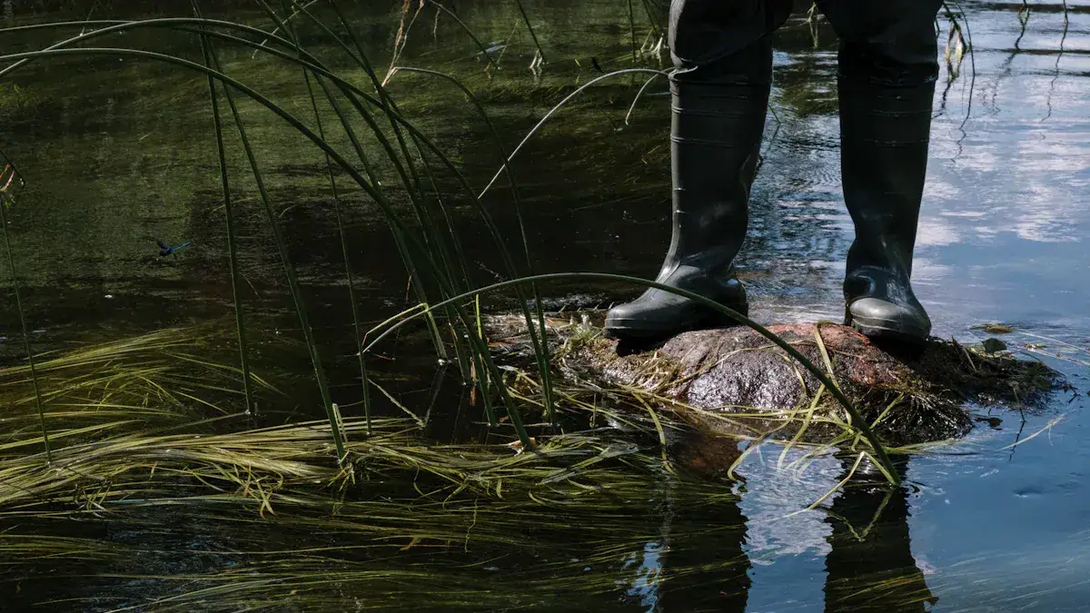 Protective waterproof rubber boots worn in wet outdoor environments, suitable for fishing, farming, and industrial work. Durable, slip-resistant footwear designed for safety and comfort in waterlogged areas.
