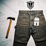 Workwear jeans with price tag, surrounded by hand tools and sketches of tools on shaded background.