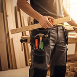 Cutting wood in a woodworking workshop with tools and materials for custom clothing uniforms manufacturing in China.