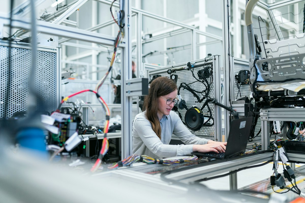 Adult commercial print plant technician at production workstation