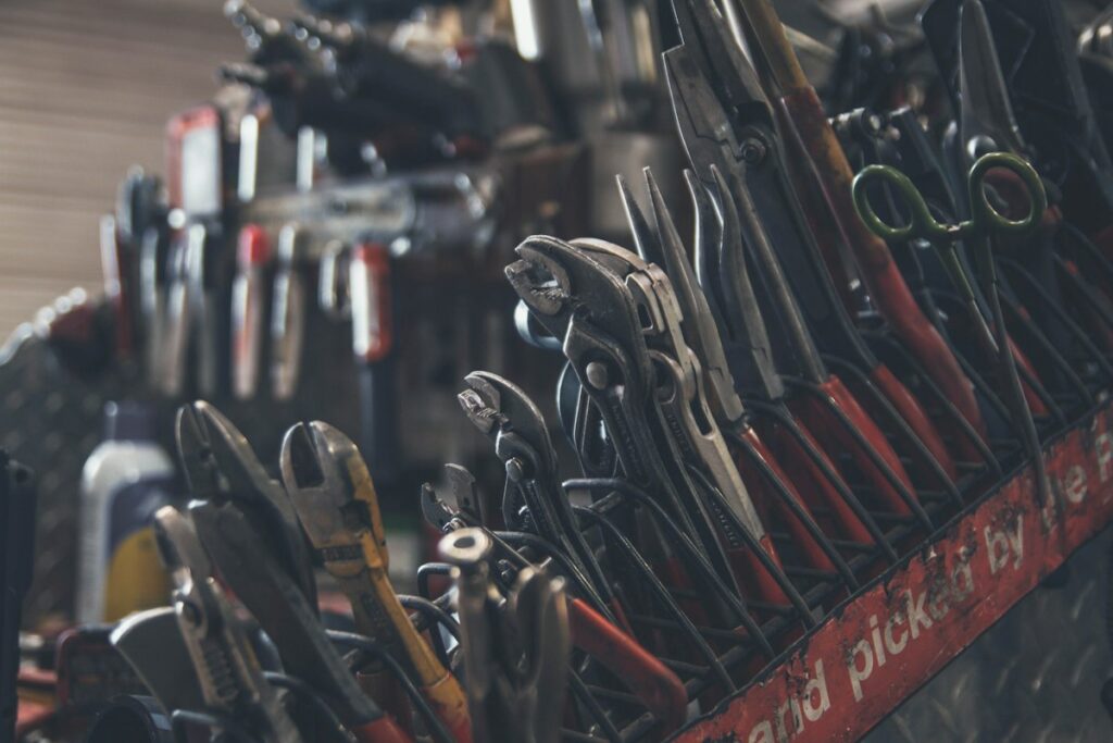 Adult hardware store floor associates organizing tools and supplies in a retail aisle