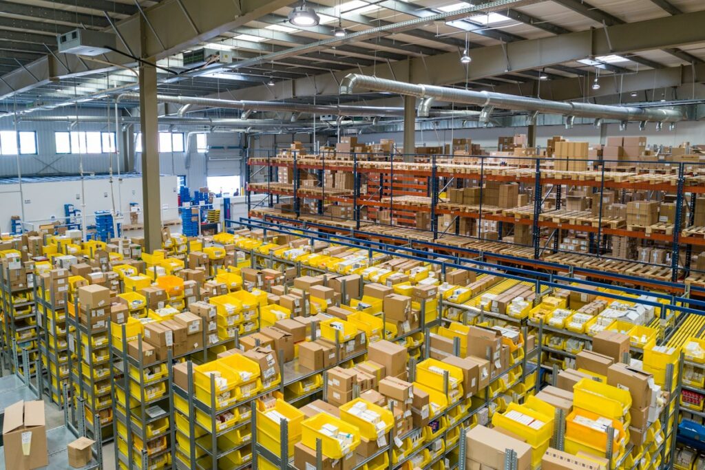 Storage facility attendant work area with organized warehouse shelving and cartons